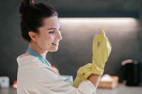 cleaning-young-dark-haired-woman-cleaning-kitchen-content